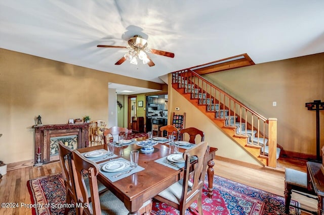 dining space featuring ceiling fan and hardwood / wood-style floors