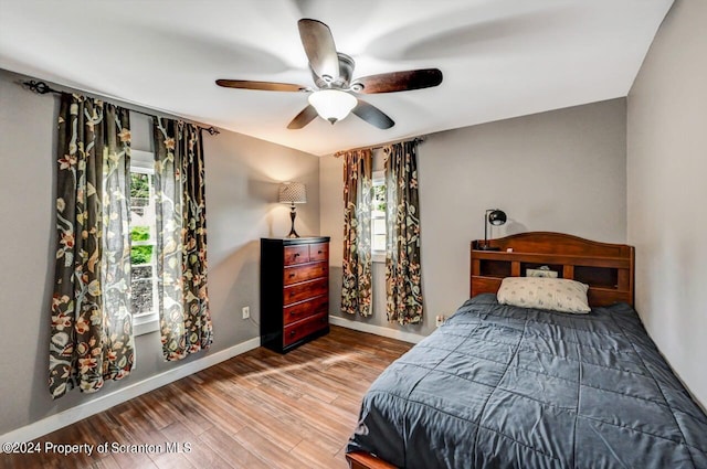 bedroom featuring hardwood / wood-style floors and ceiling fan