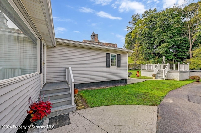 exterior space featuring a lawn and a patio area