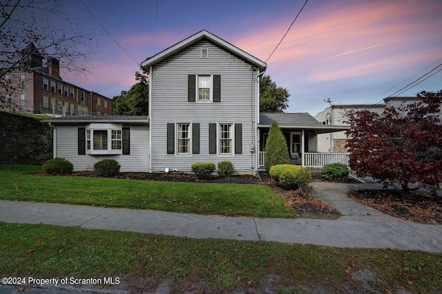 view of front of home with a yard and covered porch