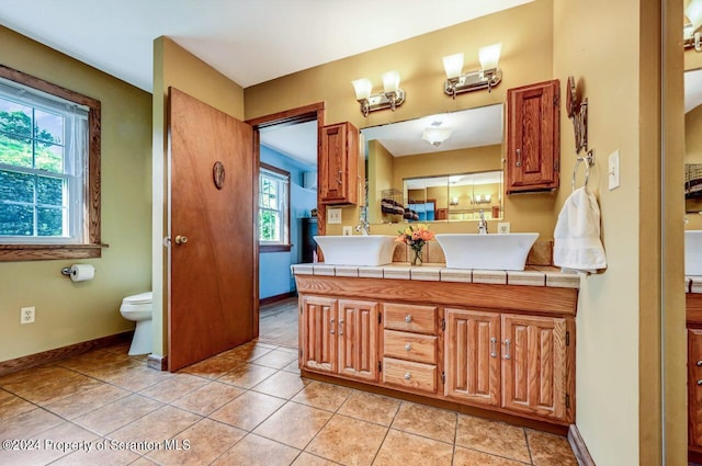 bathroom featuring tile patterned floors, vanity, and toilet