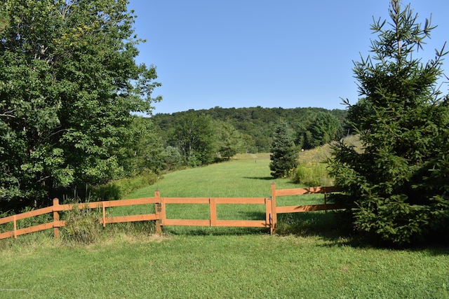 view of gate featuring a yard and a rural view