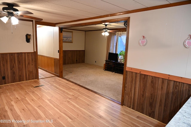 empty room featuring ceiling fan and light hardwood / wood-style flooring