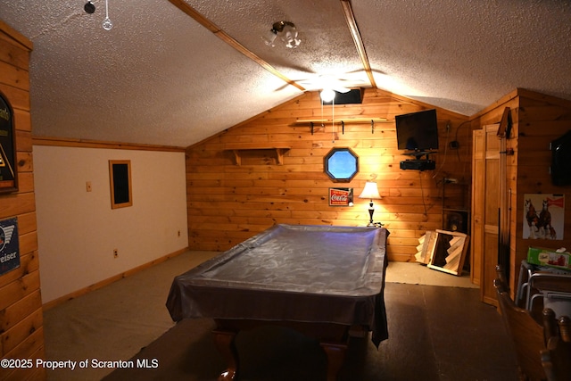 recreation room featuring a textured ceiling, vaulted ceiling, wooden walls, and billiards