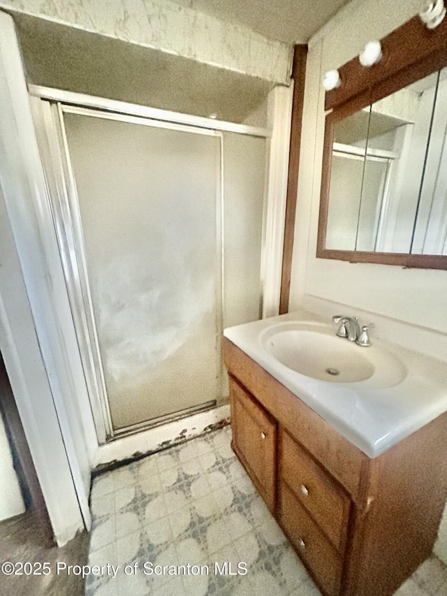 bathroom featuring a stall shower, vanity, and tile patterned floors