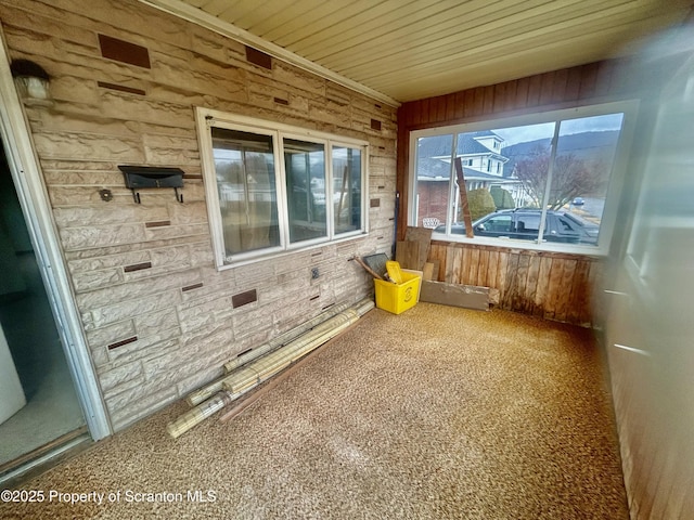 unfurnished sunroom with wooden ceiling