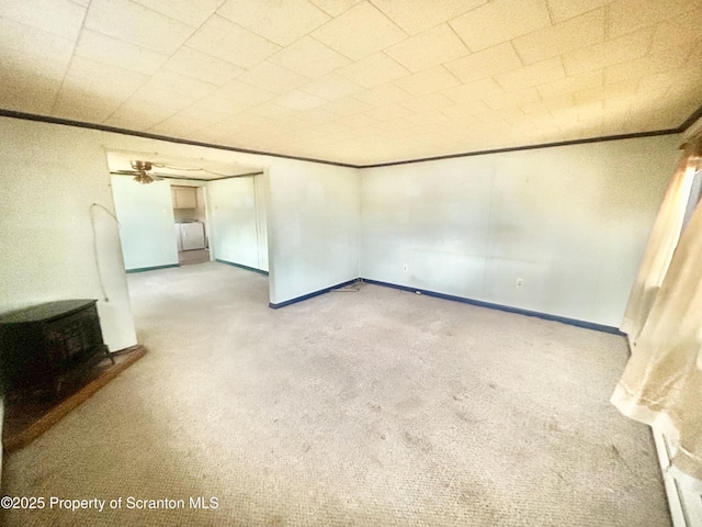 unfurnished room with carpet floors, ornamental molding, and baseboards