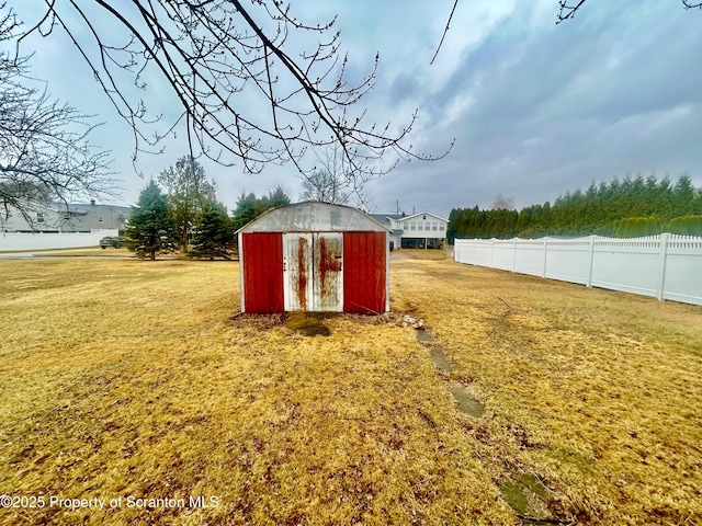 view of shed featuring fence