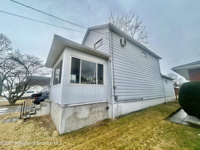 view of side of home with a lawn and heating fuel