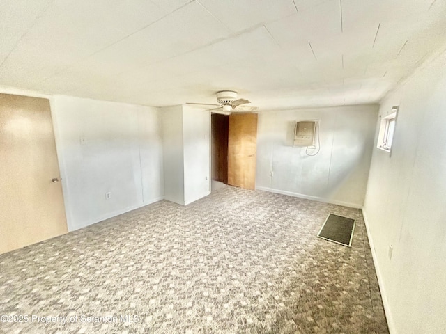 spare room with carpet floors, a wall mounted air conditioner, and ceiling fan