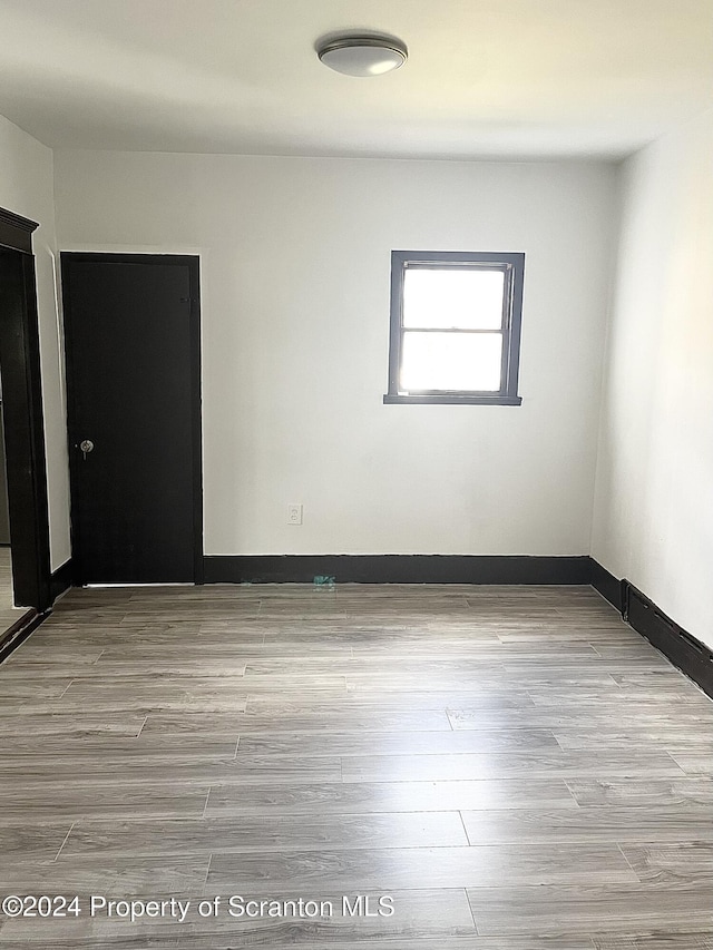 spare room with light hardwood / wood-style flooring