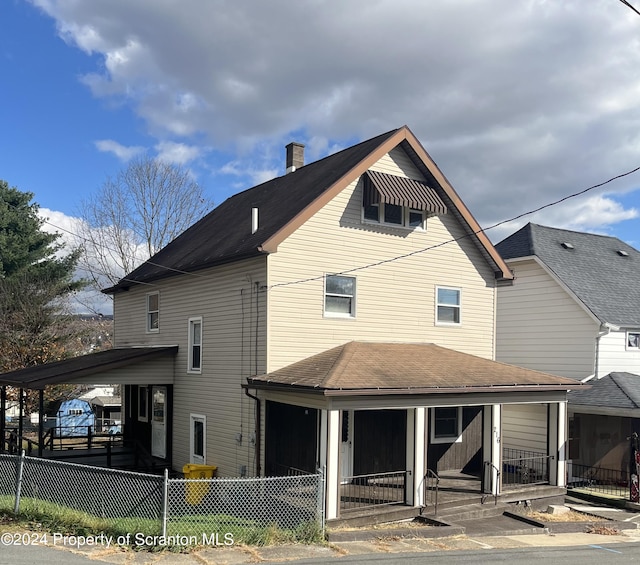 back of property with a porch