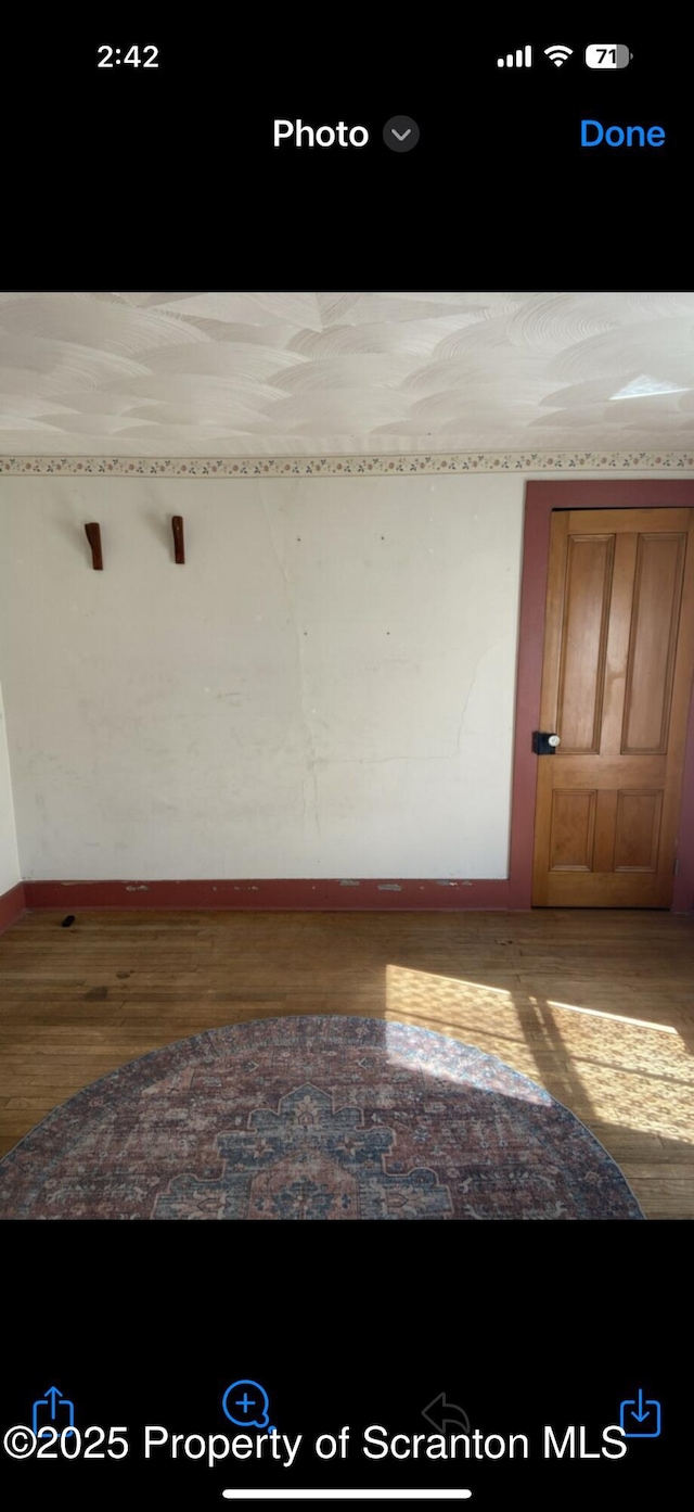 empty room featuring wood finished floors