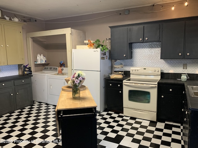 kitchen with washer and dryer, backsplash, white appliances, and light floors