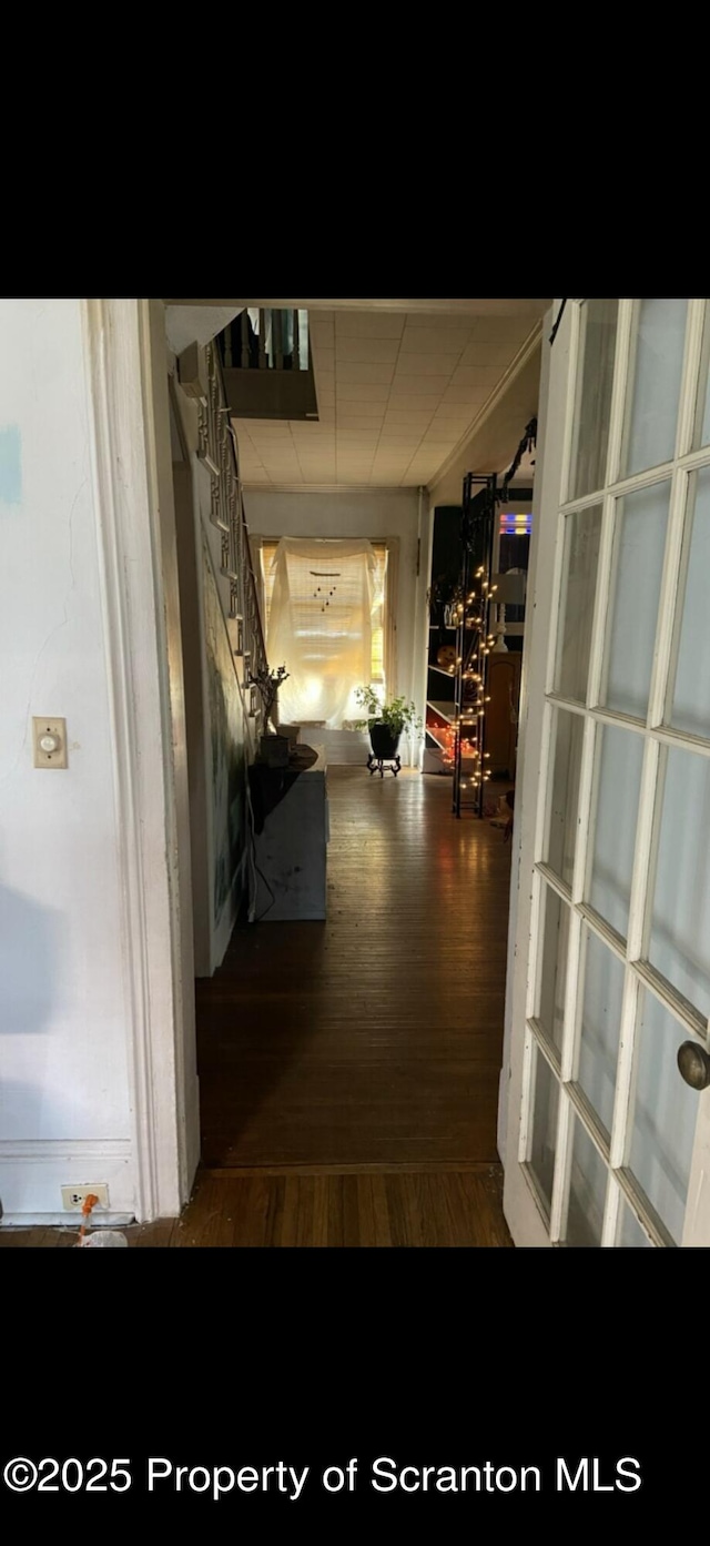 hallway with wood finished floors and stairs