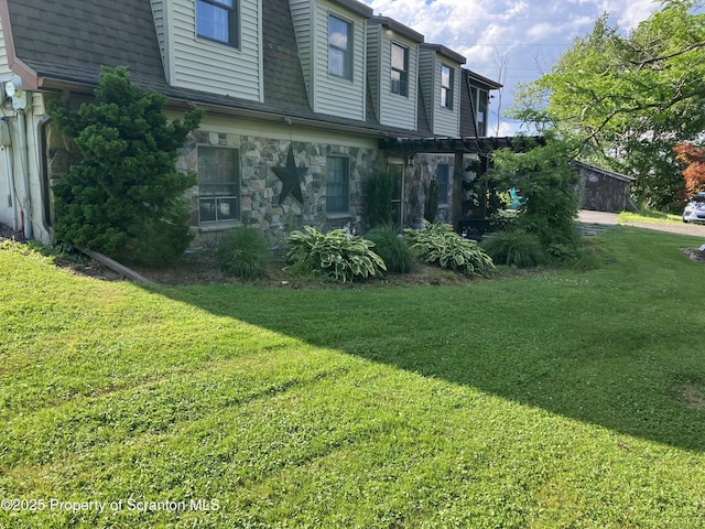 view of side of property with a yard