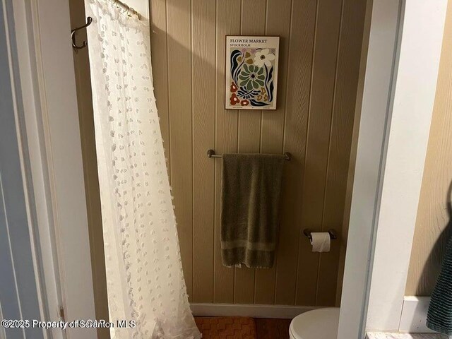 121 Burcher Ave, South Abington Twp, PA 18411 - bathroom featuring toilet, wood walls, and a shower with curtain