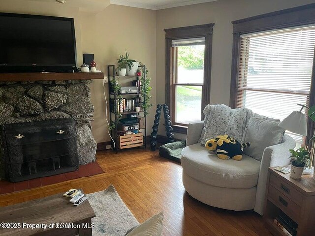 121 Burcher Ave, South Abington Twp, PA 18411 - living area with a stone fireplace, crown molding, and wood finished floors