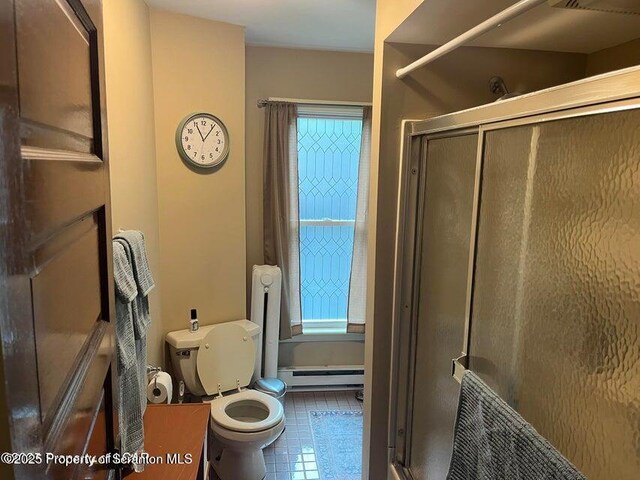 121 Burcher Ave, South Abington Twp, PA 18411 - bathroom featuring a baseboard heating unit, a stall shower, toilet, and tile patterned flooring