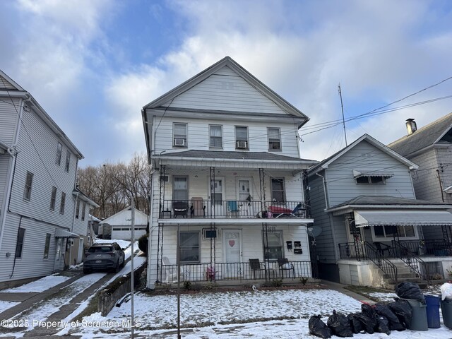 view of front of house featuring a balcony