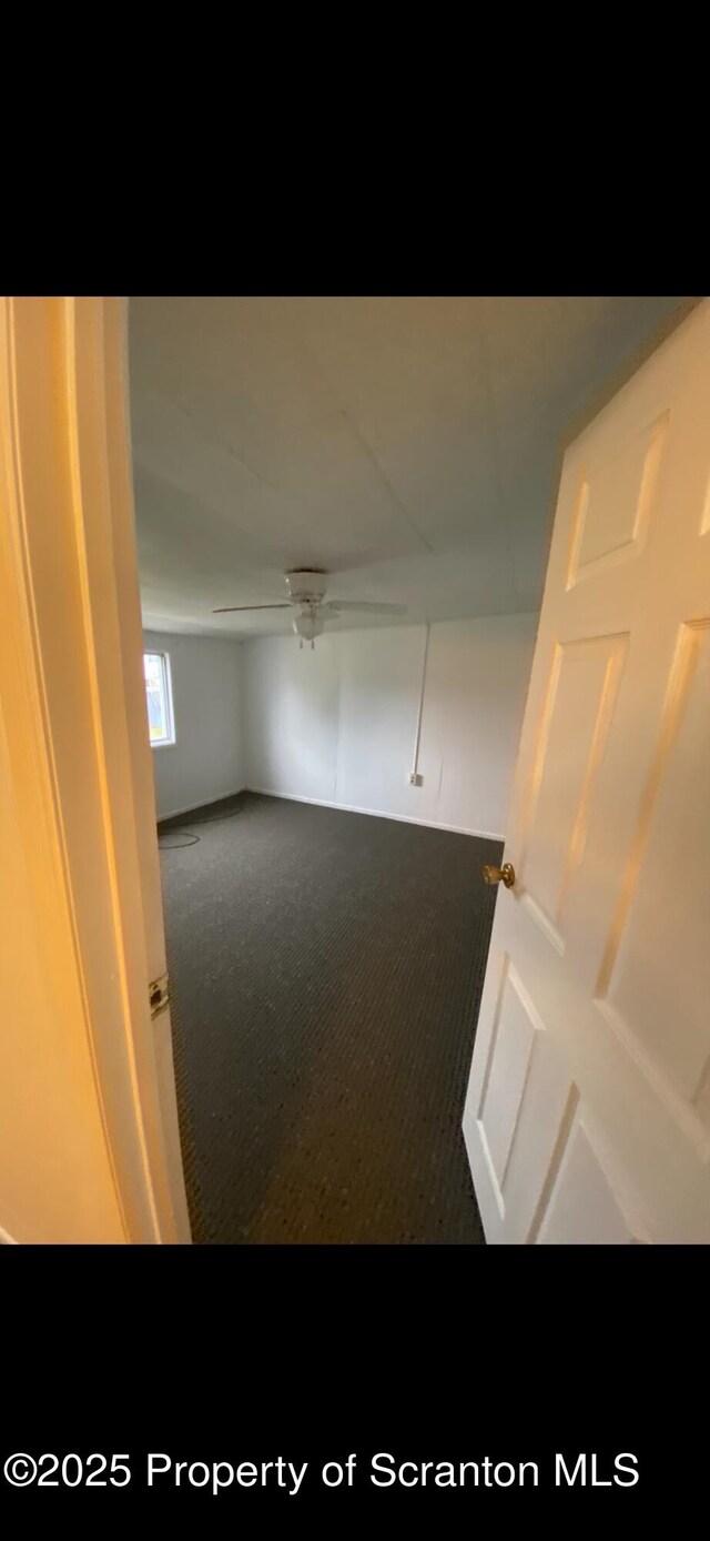 unfurnished room featuring carpet floors and ceiling fan