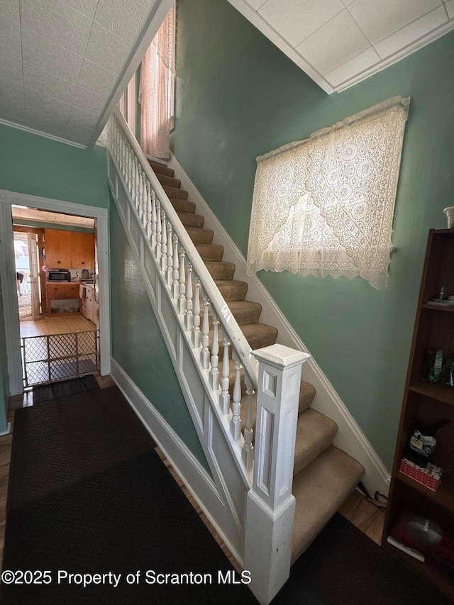 staircase with crown molding