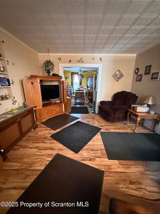 living room featuring ornamental molding and wood finished floors