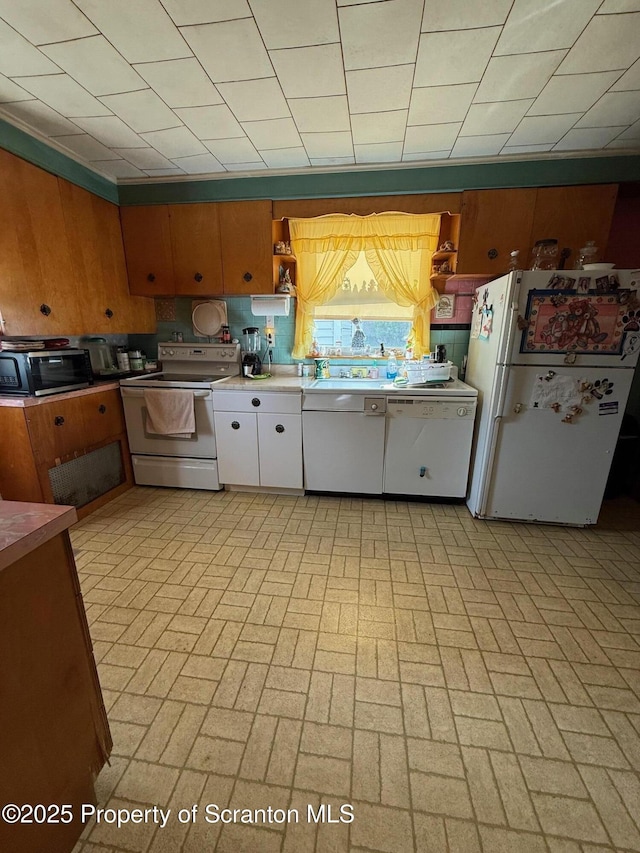 kitchen with open shelves, a toaster, brick patterned floor, and white appliances