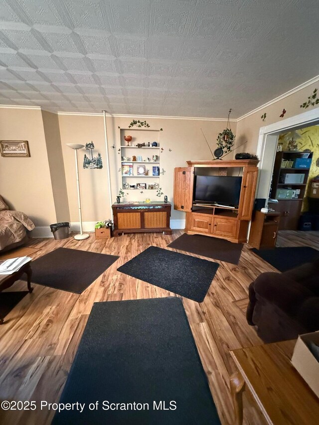 living room with crown molding and wood finished floors