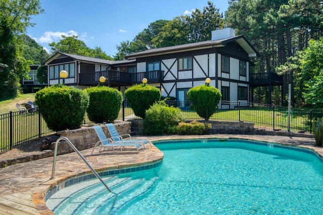 view of pool featuring a lawn