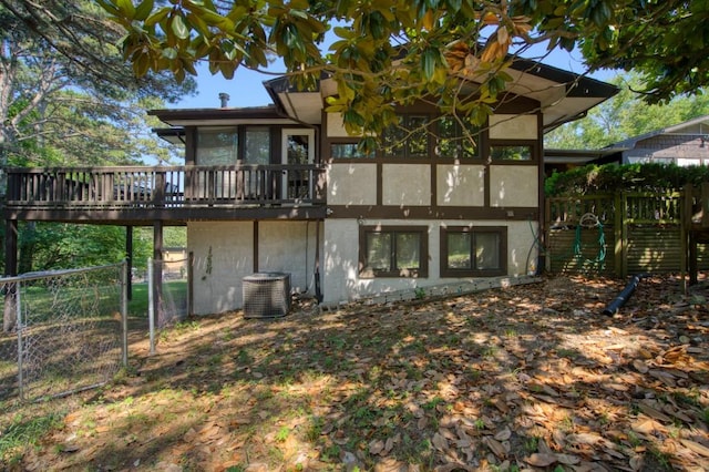 back of house featuring central AC unit and a deck