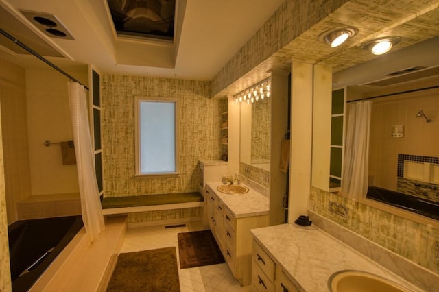 bathroom featuring tile flooring, tasteful backsplash, and vanity