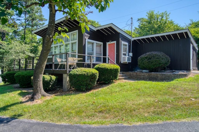 view of front of home featuring a wooden deck and a front yard