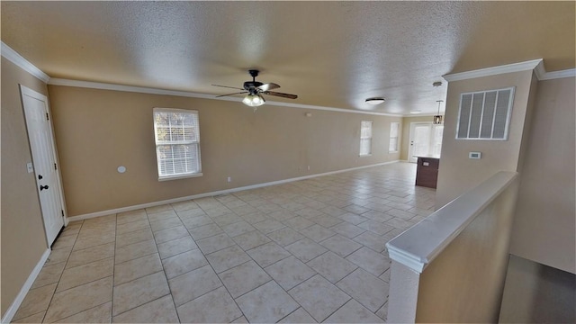 unfurnished room with light tile floors, a textured ceiling, ceiling fan, and ornamental molding