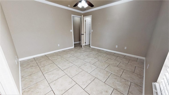 spare room with light tile flooring, ornamental molding, and ceiling fan