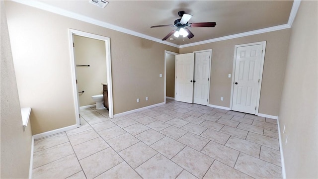 unfurnished bedroom featuring connected bathroom, ceiling fan, light tile floors, crown molding, and two closets