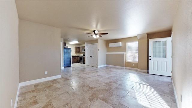 unfurnished living room with light tile floors, ceiling fan, and a wall mounted air conditioner