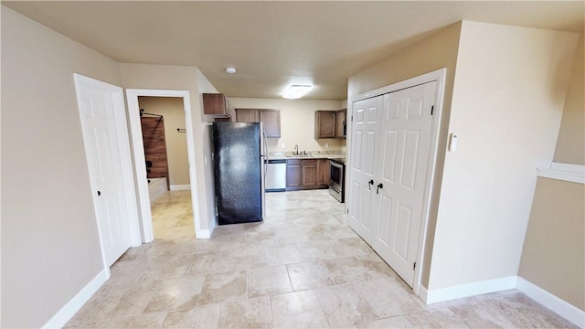 kitchen with black fridge, sink, light tile floors, and dishwasher