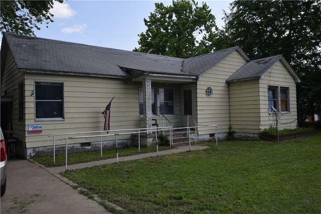 single story home featuring crawl space, roof with shingles, fence, and a front yard