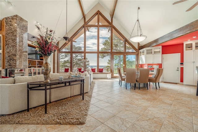 living room featuring light tile floors, ceiling fan, and high vaulted ceiling