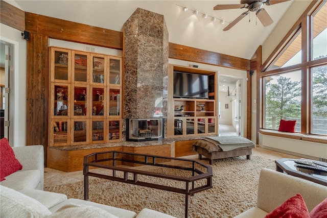 18515 Dream Catcher, Garfield, AR 72732 - living room with a wood stove, ceiling fan, light tile floors, high vaulted ceiling, and rail lighting