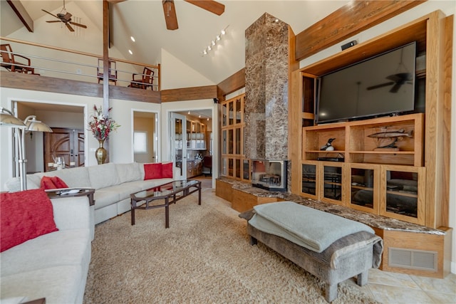 18515 Dream Catcher, Garfield, AR 72732 - living room featuring high vaulted ceiling, a fireplace, light tile flooring, ceiling fan, and beamed ceiling