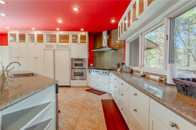 18515 Dream Catcher, Garfield, AR 72732 - kitchen with light tile flooring, backsplash, sink, white cabinetry, and wall chimney exhaust hood