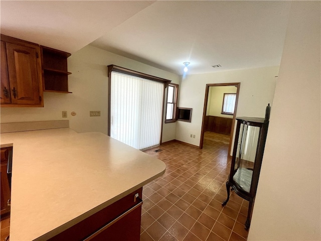 kitchen featuring dark tile flooring