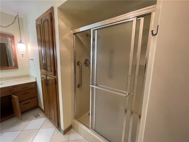 bathroom with walk in shower, vanity, and tile floors