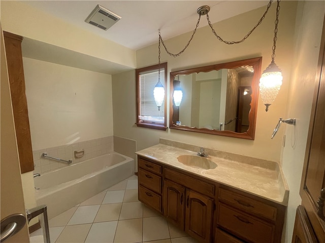 bathroom with a bathing tub, tile flooring, and vanity