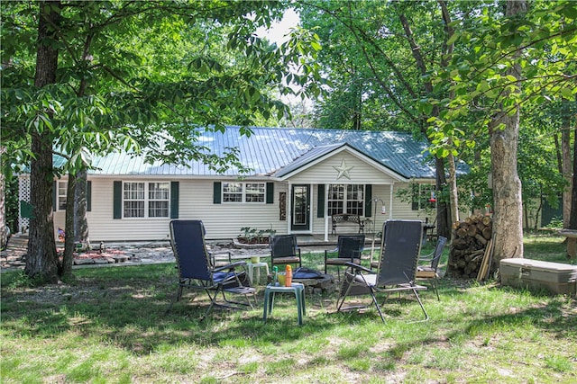 rear view of house featuring a yard