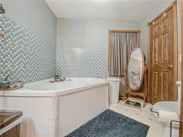 bathroom with tasteful backsplash, tile flooring, and a bathtub