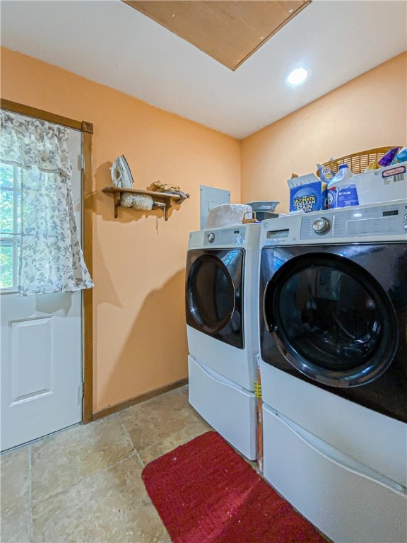 laundry room featuring independent washer and dryer and light tile floors