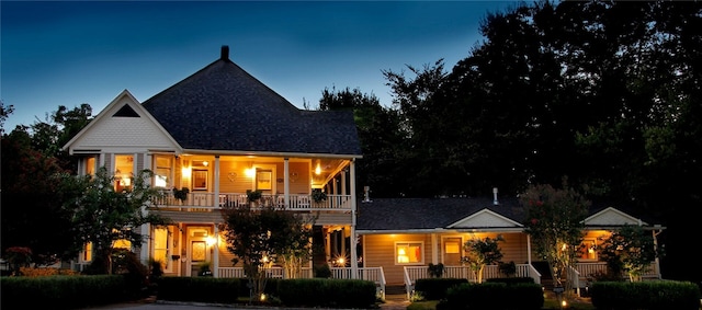 view of front of property featuring a balcony and covered porch